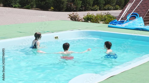Kids enjoy playtime in the pool during a sunny day