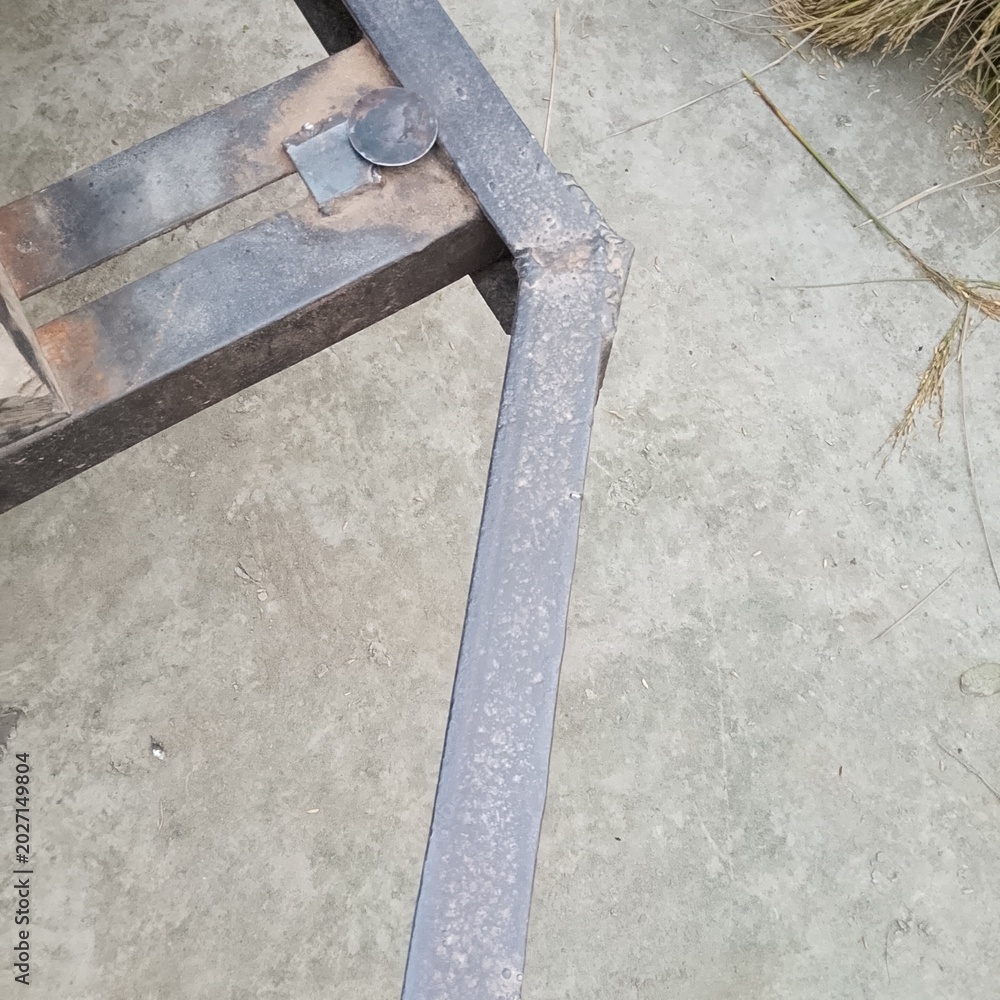 Fototapeta premium Aerial view of a bench on a textured pavement with scattered debris