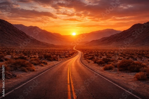 Soft glowing sunset over barren desert route amidst high elevation hills