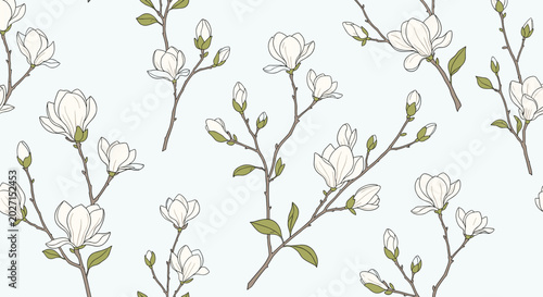Elegant seamless pattern of white magnolia flowers on branches with green leaves against a soft light blue background.