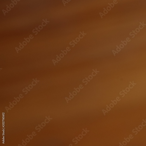 Smooth brown silk fabric flowing in soft warm light