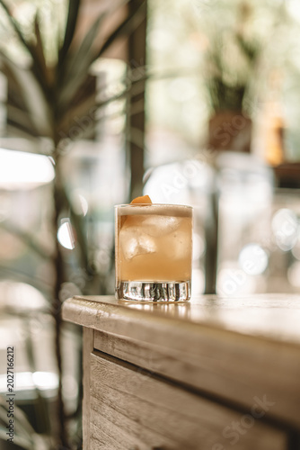 Classic Cocktail with Ice on Wooden Bar Counter