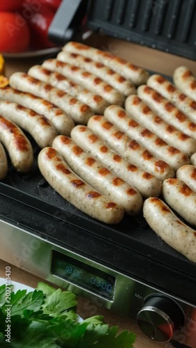 Batch of Sausages Roasting on Modern Electric Home Grill