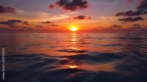 Serene Ocean Sunset with Fiery Sky and Gentle Waves.