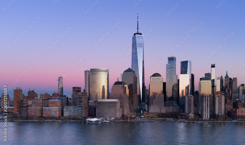Fototapeta premium Manhattan skyline. New York City wide panoramic skyline. New York cityscape along the waterfront. NYC aerial skyline above downtown Manhattan. New York City landscape with skyscrapers.