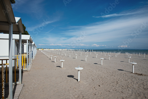 Empty Autumn Beach With Closed Bathhouse Cabins And Umbrella Stands – Bibione Off-Season Landscape