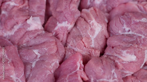 Raw meat with marbling. Chilled fresh pork pieces arranged for marketing displays. Closeup of prime raw pork with marbling displayed for attractive commercial presentation