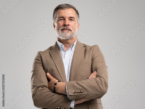 Entrepreneur in jacket smiling, Happy mid adult, mature age man standing, smiling, isolated on white background