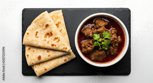 Indian mutton curry with paratha isolated on white background