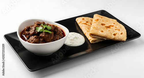 Indian meat curry, flatbread, raita