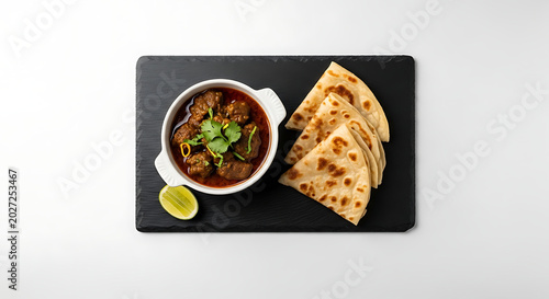 Meat curry with flatbread, isolated on white