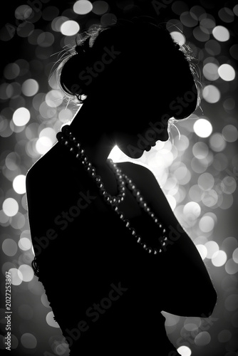 Artistic silhouette of woman with pearl necklace against black and white bokeh lights, elegant and mysterious. Fashion, glamour, silhouette portrait, elegance, monochrome.
