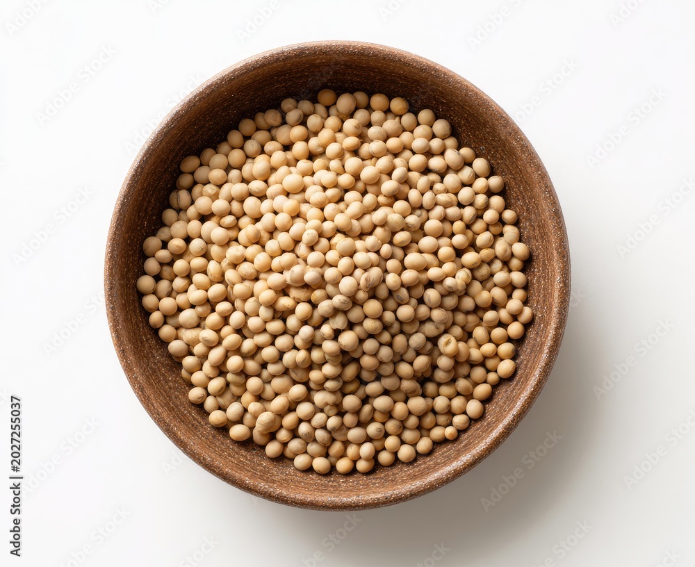 Fototapeta premium Top-down view of a rustic bowl brimming with small, light brown, oval-shaped legumes