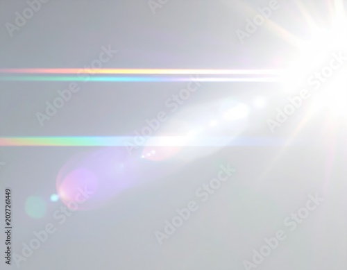 Bright, radiant light flares with colorful spectral streaks against a pale background