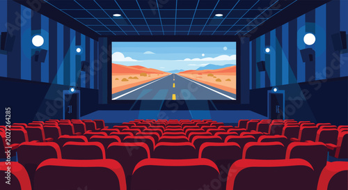 View from the back of a movie theater shows empty red seats facing a screen displaying a road trip across a desert.