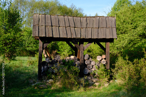 covered woodshed with firewood in the park