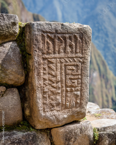 Ancient Inca stone carving near Machu Picchu mountains for Peru travel and archaeological heritage