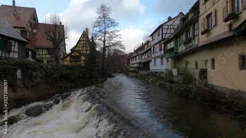 The Weiss river running between half timbered houses, Kaysersberg, Alsace, France, Europe. River with strong current flowing through the rocks.