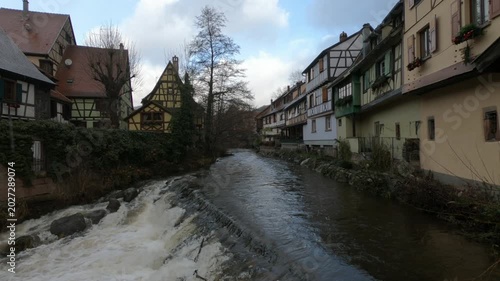 The Weiss river running between half timbered houses, Kaysersberg, Alsace, France, Europe. River with strong current flowing through the rocks.