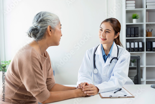 Doctor providing comforting support to an elderly woman during a healthcare check up, building trust and empathy in the clinic