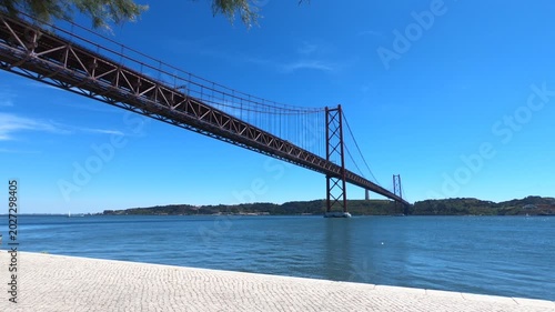 Christ-King and the 25 April Bridge (Ponte 25 de Abril), a steel suspension bridge located in Lisbon, Portugal, crossing the Tagus River (Rio Tejo).