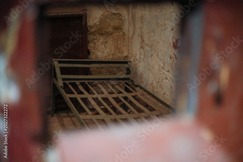 a worn metal prison bed displayed in a museum of Soviet repression stands as a silent reminder of detainees suffering and political imprisonment within NKVD and KGB detention facilities history