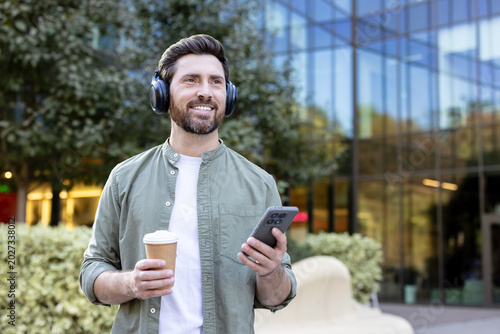 Photography Happy bearded man enjoying a refreshing coffee and listening to music using head