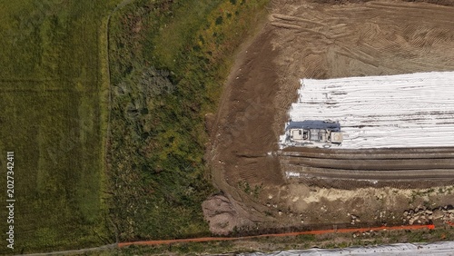 Aerial view of railway construction site with soil stabilization and heavy machinery in Italy