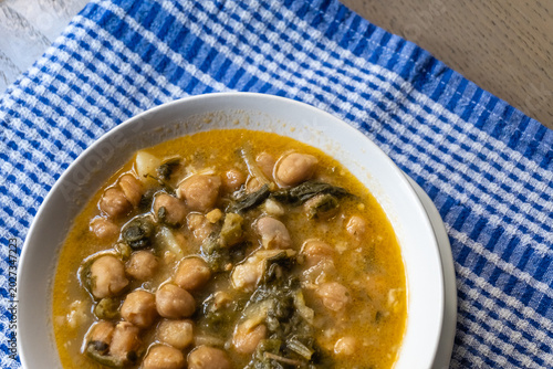 Photos Chickpea and greens stew in white bowl