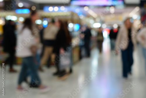 Blurred background. A shopping mall hall with people.