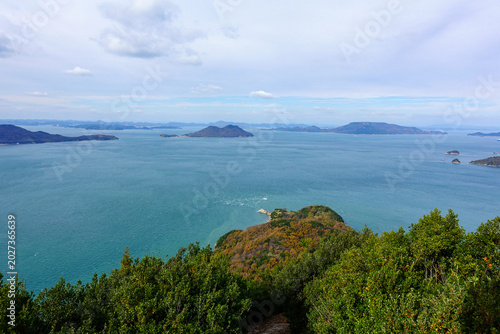 Panoramic view of turquoise Seto Inland Sea and forested islands from mountain viewpoint in Shikoku Japan