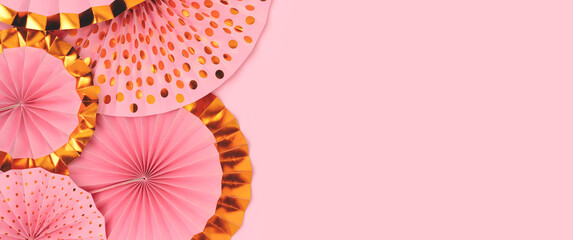 Banner with paper fans on a pink background. Place for text.