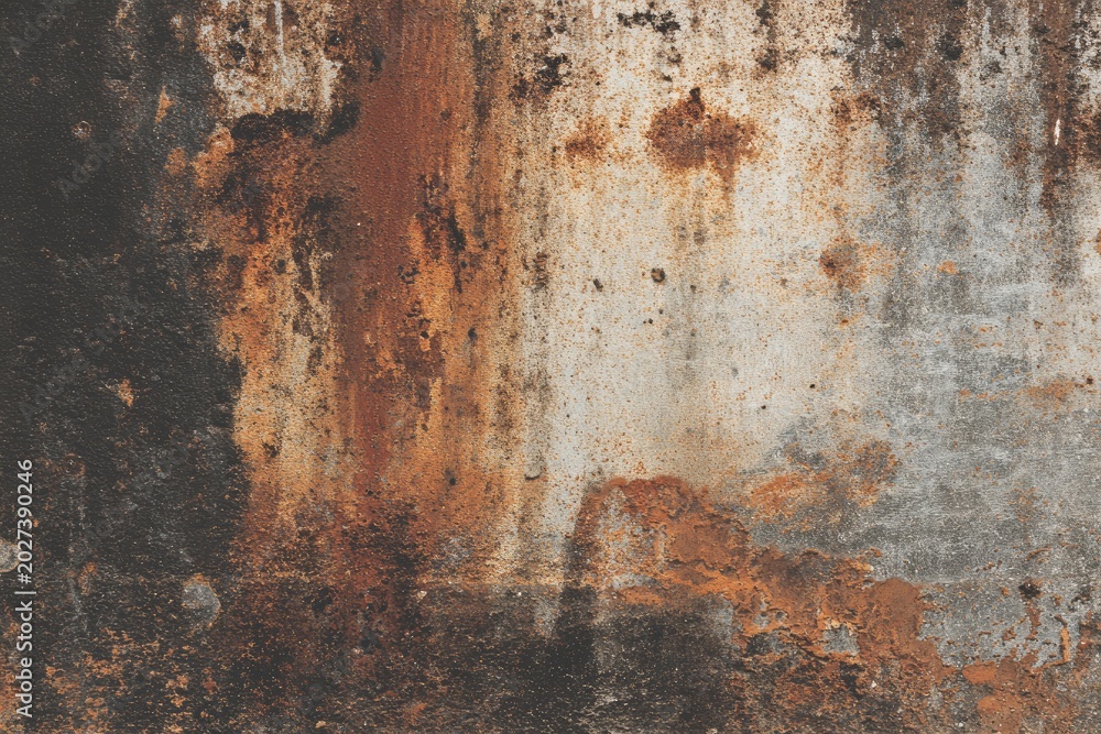 Fototapeta premium Close-up textured abstract of decaying metal with streaks of rust and grime