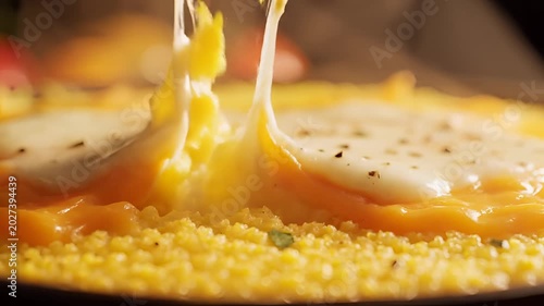 Delicious Melted Cheese Stretching Over Golden Polenta CloseUp.