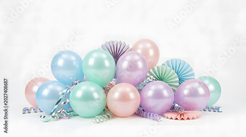 Collection of pastel balloons and paper fans with curly ribbons for a birthday party on a white background