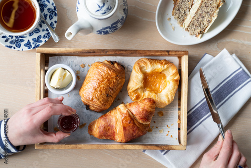 Foto Enjoying a Delightful Breakfast Spread With Pastries and Tea in a Cozy Setting