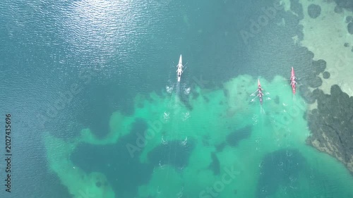 Top Down Aerial View of Rowing Boats Competing in a Race on Turquoise Sea. High quality 4k footage