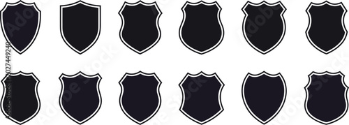 Photography Twelve black shield shapes with white outlines in two rows on a dark background