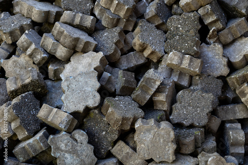 Close-up abstract texture of stacked paving tiles.