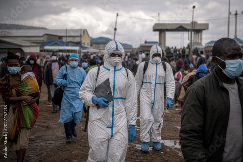Vigilant healthcare warriors patrol a crowded settlement fighting an insidious viral threat