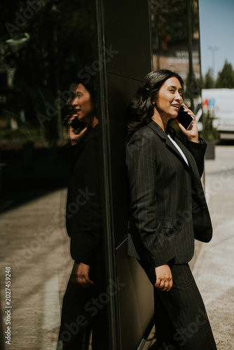 Business woman talks on pho...