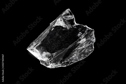 Close-up of a Clear Jagged Crystal Fragment Isolated on Black Background with Sharp Reflective Edges