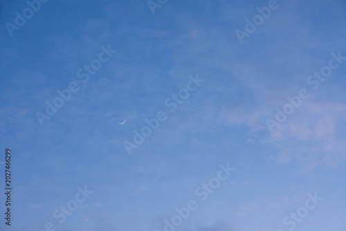 Minimalist sky landscape with single crescent moon