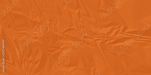 Orange abstract fabric texture with subtle creases