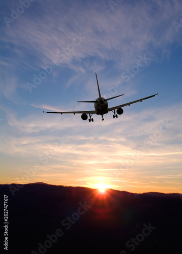 Airplane taking off into a sunset