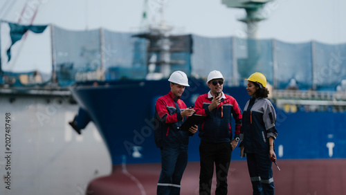 Φωτογραφία Happy team professional engineer, worker, technician use clipboard discuss work, walk in steel metal manufacture factory plant industry