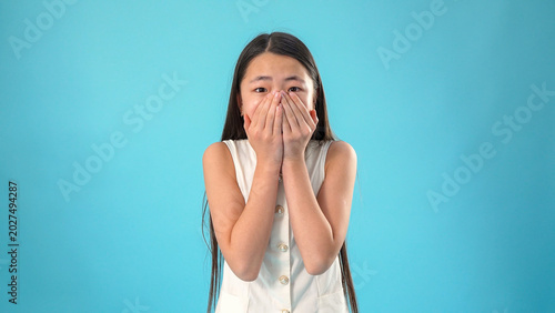 Close up portrait of scared shocked young asian woman looking