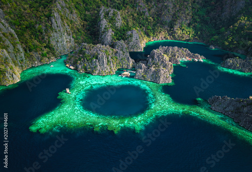 Twin Lagoon, located on Coron Island in Palawan, Philippines, is a breathtaking natural attraction featuring two crystal-clear lagoons separated by a dramatic limestone wall.