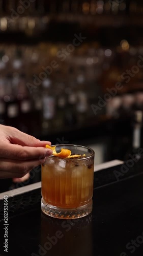A skilled bartender expertly crafts a fresh cocktail behind a stylish bar counter