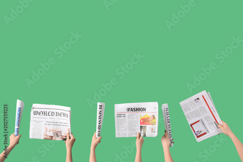 Women with newspapers on gr...